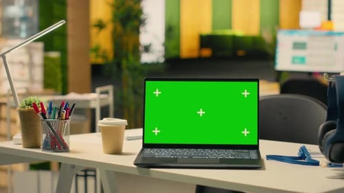 Green Screen Mockup on Laptop at Empty Corporate Desk