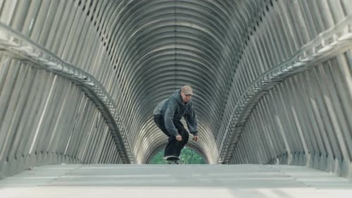 Skateboarder Performing Trick in Modern Tunnel