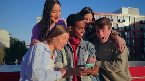 Young Adults Laughing at Smartphone Together