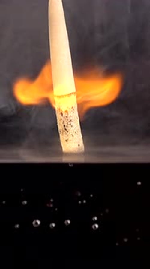 Burning Matchstick Plunging into Water with Bubbles