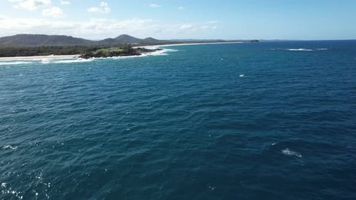 Breathtaking Aerial View Of Deep Blue Ocean Waves Hitting Coastline