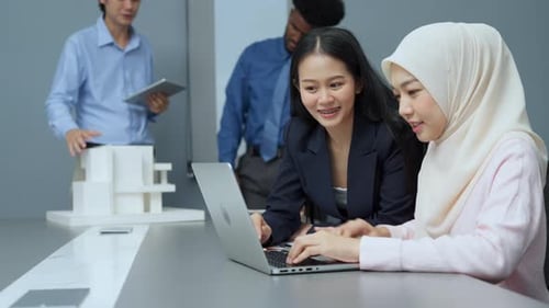 Smiling Colleagues Collaborate in a Modern Office