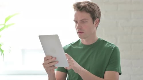 Young Adult Celebrates Digital Success on Tablet Device