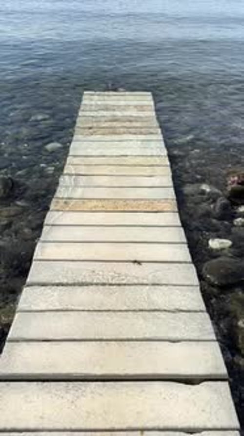 A Peaceful Wooden Dock Over Calm Waters Offering Serenity and Relaxation a Picturesque Getaway