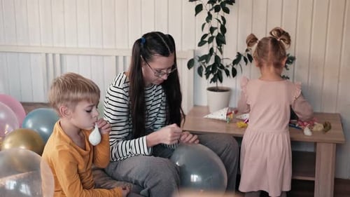 Children Inflating Balloons for a Birthday Party