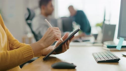 Woman using tablet in bright, modern office