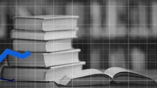 Multiple blue graphs moving over grid network against stack of books