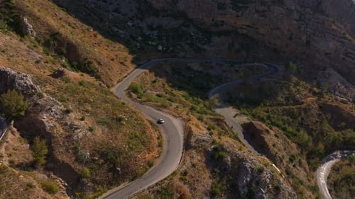 Aerial view of winding road through mountains and vegetation, Turkey.