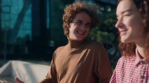 College Friends Smiling and Chatting Outdoors at Modern University Campus