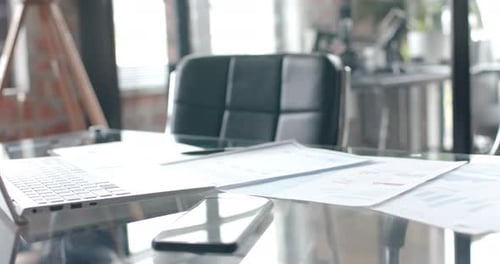 Close up of desk with smartphone, laptop and documents at home, office slow motion