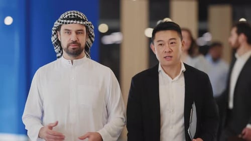 Two Businessmen Talking and Walking in Modern Office