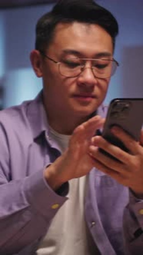 Adult Using Phone, Sitting Indoors