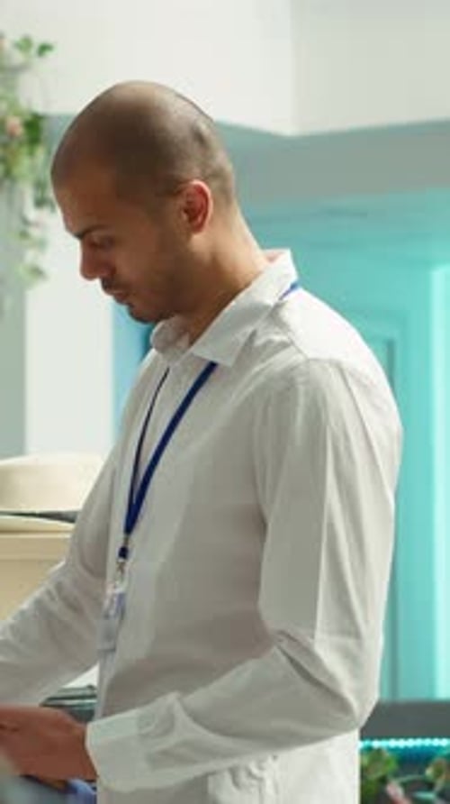 Adult Looking at Mobile Phone in Retail Store
