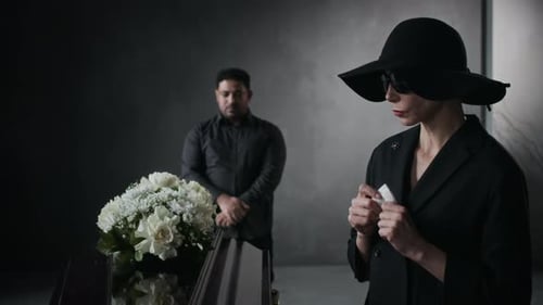 Woman and Man Mourning Loss at Funeral
