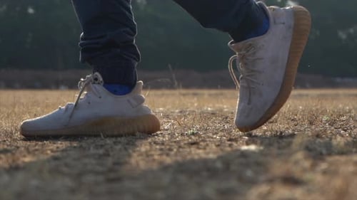 walk in dry grass with the shoe a backlight cinematic shot
