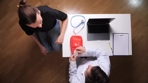 Doctor Explains Medication to Patient in Office, Top View