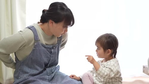 Child and Young Adult Playing Hand Games Together
