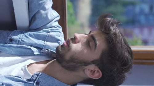 Vertical video of The man is frustrated. Annoyed.