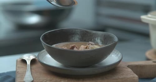 Hearty Beef Stew Being Ladled Into Ceramic Bowl Closeup in Ultra Slow