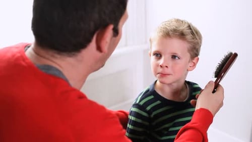 Father Brushing the Hair of his Young Son