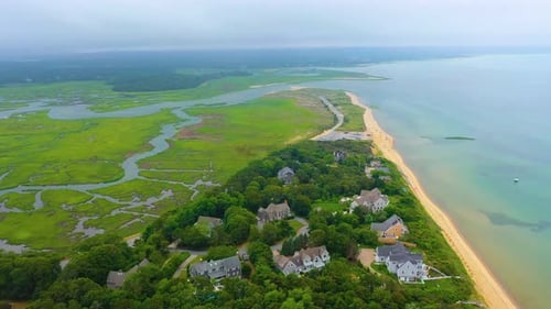 Aerial View of Coastal Marshes and Shoreline with Homes on an Overcast Day