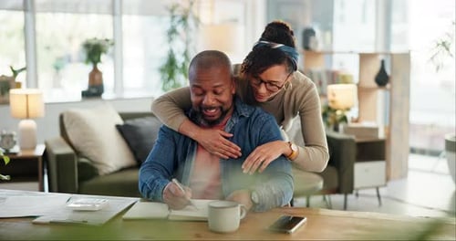 Couple Embrace at Desk Working From Home