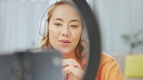 Media, podcast or asian woman vlogger in living room streaming, recording