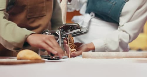 Pasta, machine and hands of chefs in kitchen at restaurant for bonding, learning or cooking lesson