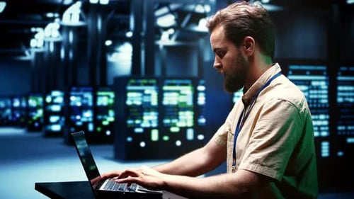 Programmer Checking Server Rigs for Data Center Maintenance