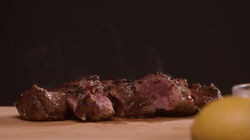 Delicious Sliced Steak on Wooden Cutting Board