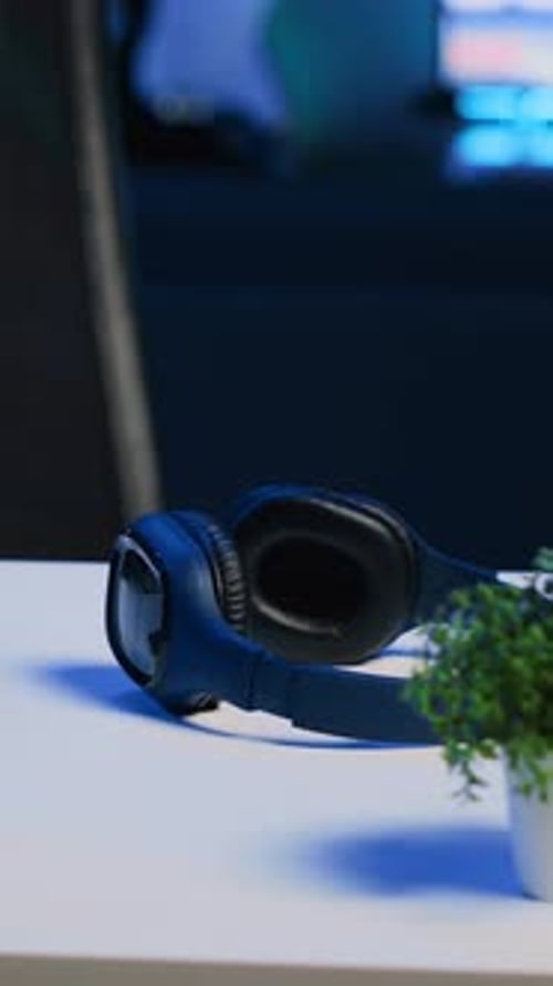 Vertical Video Laptop Headphones and Mini House Plants on Table in Apartment Room