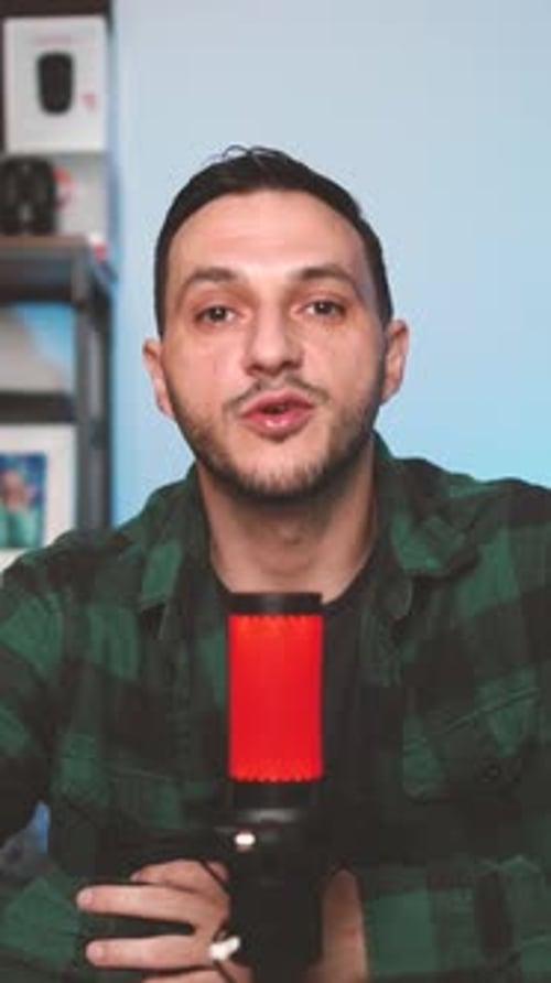 Man Talking into Microphone in Home Studio