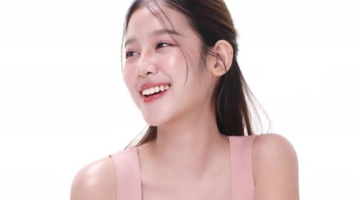 Close up portrait beautiful young Asian woman with healthy facial skin over white background.