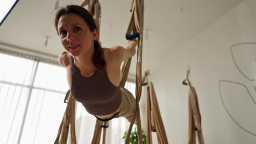Woman Does Aerial Yoga Upside Down