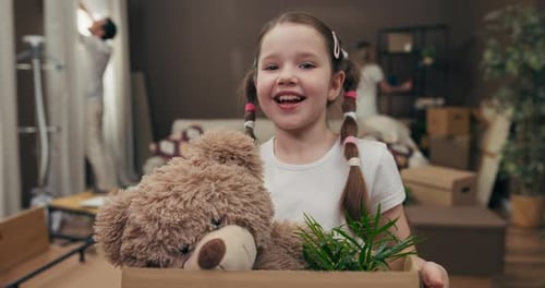 Portait of Happy Kid in the Middle of New Modern Apartment Moving in Process Zarton Boxes with
