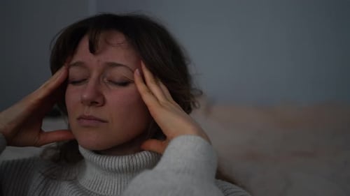 Woman Suffering From Migraine Touching Head