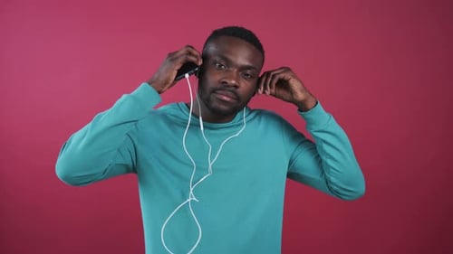 Man Puts in Headphones and Selects Music