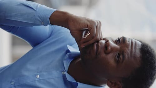 Vertical Video Sad Businessman Fired From Job Sitting Sadly Outdoors with the Office in the City