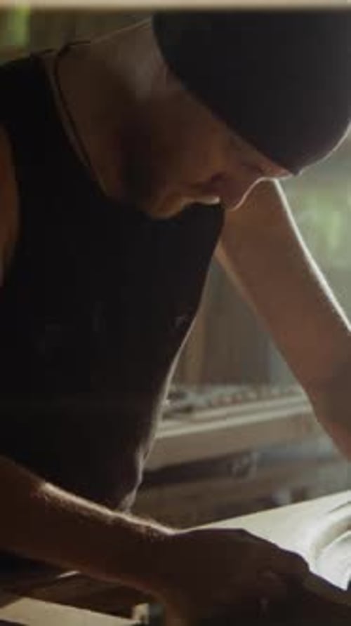 Bearded Carpenter Works on Round Wooden Frame in Carpentry Shop