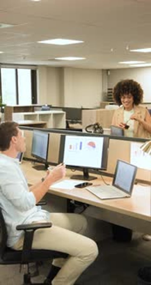 Vertical video: Diverse coworkers eating salad after dessert offer while reviewing charts at desk