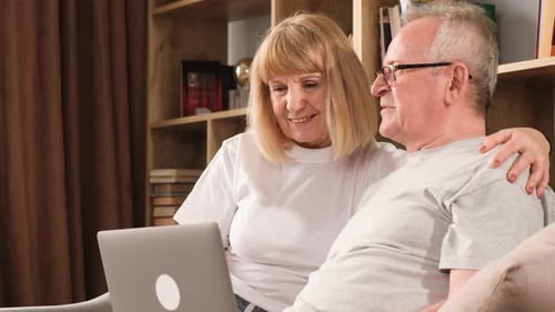 Senior Couple Enjoying Laptop Together in Home