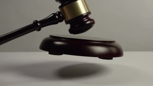 Wooden Gavel Being Placed on Stand