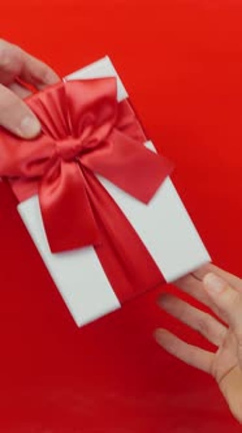 Giving a Gift Box with Red Ribbon