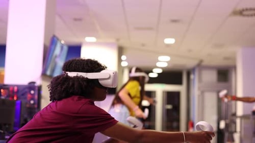 Two gamers wearing virtual reality headsets immerse themselves in an exhilarating gaming experience