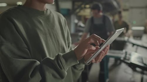 Industrial Factory Supervisor Using Digital Tablet at Work