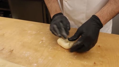a chef makes bread in a bakery
