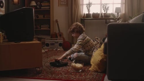 Millennial Boy Starting Playing Console Video Game on Tube TV in 90s