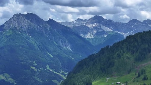 Lush Mountain Range Under Cloudy Skies