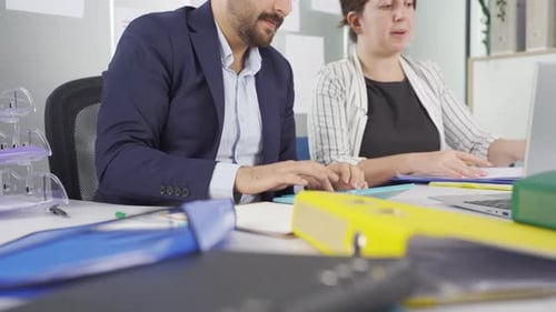 Corporate Colleagues Reviewing Financial Data in Modern Office