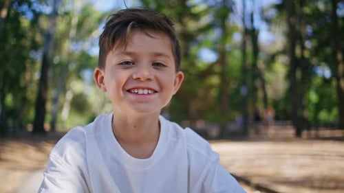 Cheerful Kid Looking Camera at Sunshine Forest Portrait Happy Child at Park